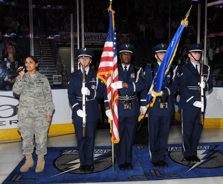 Airman 1st Class Brianna McGuffie sings the National Anthem along side the 927th Air Refueling Wing color guard at the March 6 Tampa Bay Lightning's hockey game. The 45th Aeromedical Evacuation Squadron, attached to the 927th ARW, was recognized at the game for their efforts during Operation Unified Response and the Haiti relief after the earthquake.  (U.S. Air Force photo/Tech. Sgt. Denise Hauser)