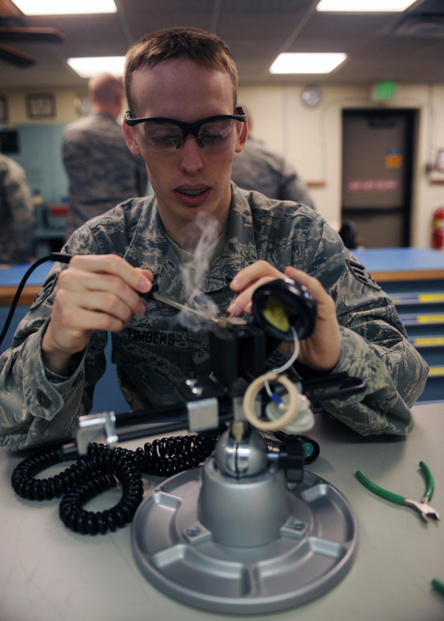 MINOT AIR FORCE BASE, N.D. -- Senior Airman Apollo Timbers, 91st Missile Maintenance Squadron strategic communications technician, re-solders a Rapid Execution and Combat Targeting (REACT) system handset at Minot Air Force base March 12. The REACT system provides monitoring and retargeting of Minuteman III ICBM’s. (U.S. Air Force photo by Senior Airman Sharida Jackson)