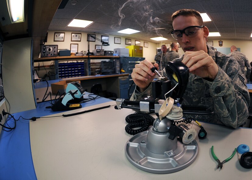 MINOT AIR FORCE BASE, N.D. -- Senior Airman Apollo Timbers, 91st Missile Maintenance Squadron strategic communications technician, re-solders a Rapid Execution and Combat Targeting (REACT) system handset at Minot Air Force base March 12. The REACT system provides monitoring and retargeting of Minuteman III ICBM’s. (U.S. Air Force photo by Senior Airman Sharida Jackson)