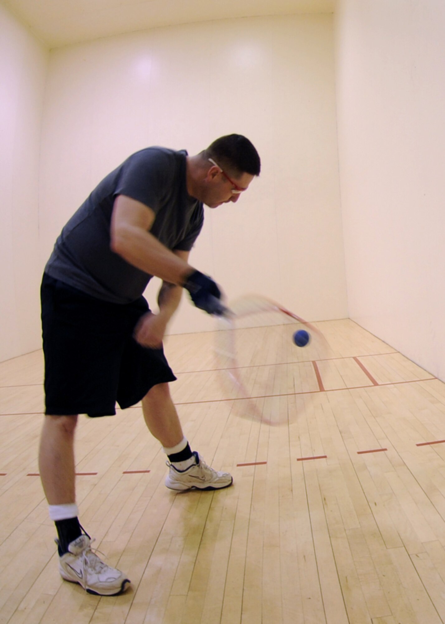 MINOT AIR FORCE BASE, N.D. – Tech. Sgt. Bud Snyder, 5th Medical Operations Squadron public health craftsman, practices a backhand return at the McAdoo Sports and Fitness Center on base March 12. The fitness center held a free racquetball clinic, which included rules, terminology and techniques. (U.S. Air Force photo by Senior Airman Sharida Jackson)