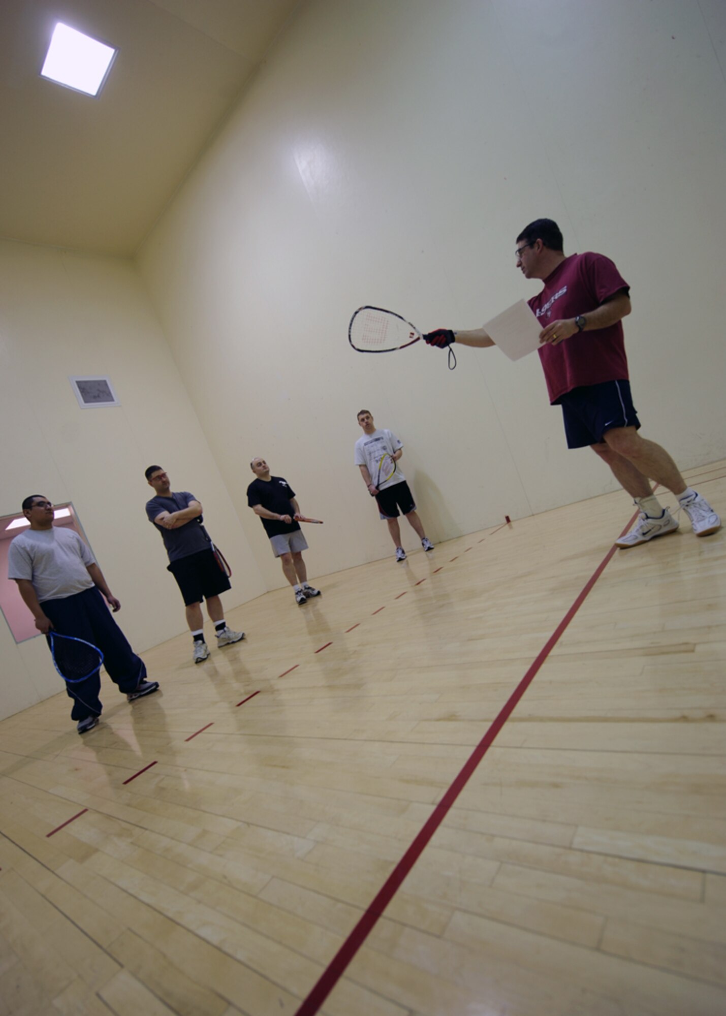 MINOT AIR FORCE BASE, N.D. – Master Sgt. John Tinker, 5th Munitions Squadron assistant armament flight chief, goes over the basics of racquetball at the McAdoo Sports and Fitness Center on Miont Air Force base March 12. The fitness center held a free racquetball clinic, which included rules, terminology and techniques. (U.S. Air Force photo by Senior Airman Sharida Jackson)
