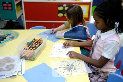 Syrin Whitcomb, left, and Kanisha Porter, right, spend time drawing during the School Age Program at the Youth Programs Center March 12. The program recently received accreditation through the Council on Accreditation, an international organization which serves as a catalyst for change to build on an organization?s strengths. Syrin is the daughter of Senior Airman Michael Whitcomb and Kanisha is the daughter of Bobbie Williams. (U.S. Air Force photo/Senior Airman Timothy Taylor)
