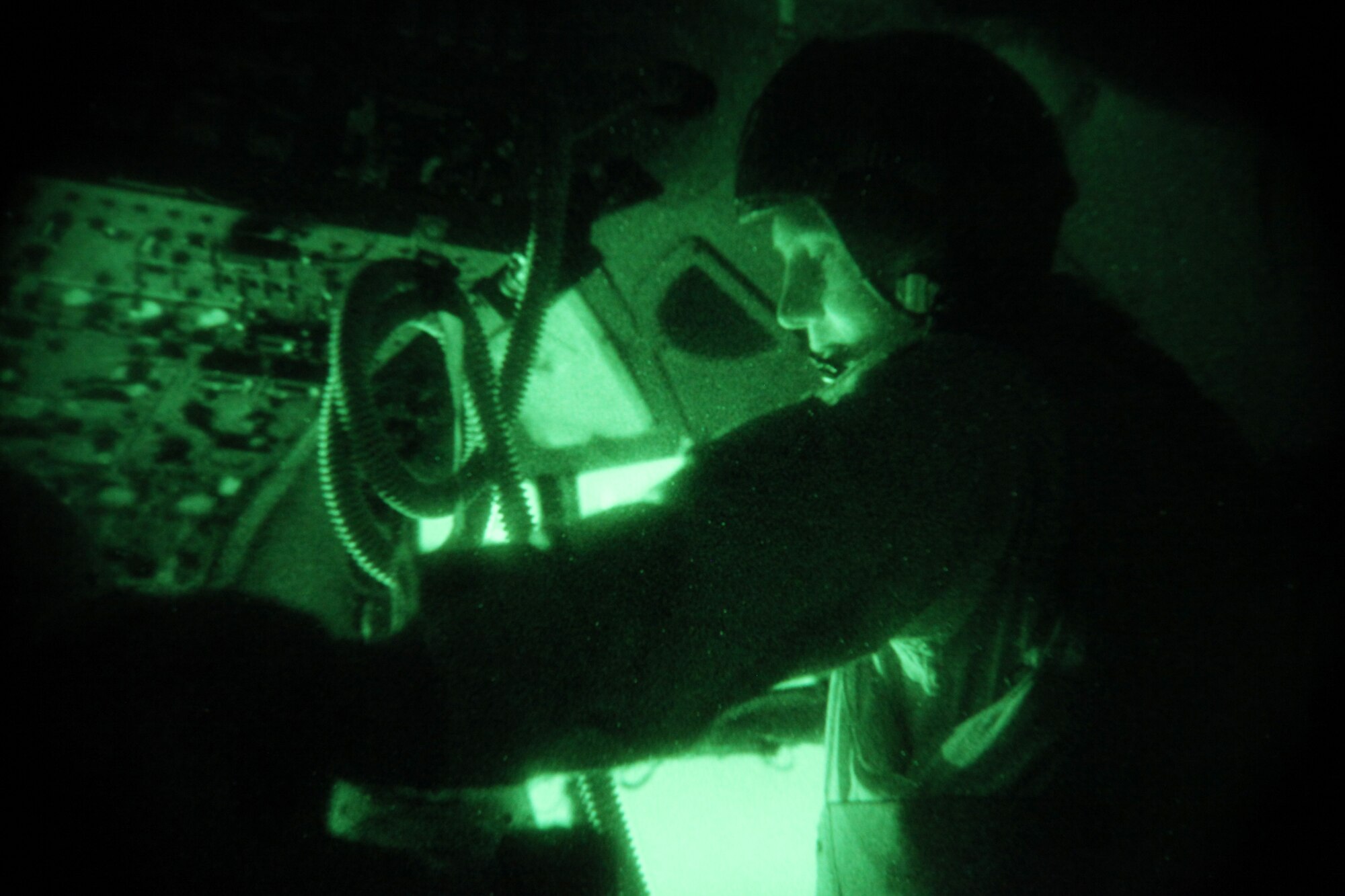 A crew member aboard an AC-130 conducts a communication check prior to takeoff March 3, 2010, from Bagram Airfield, Afghanistan.  The flight crew was providing close-air support for ground troops conducting operations in Afghanistan's Parwan province. (Defense Department photo/Army Staff Sgt. Billie J. Nelson Jr.)