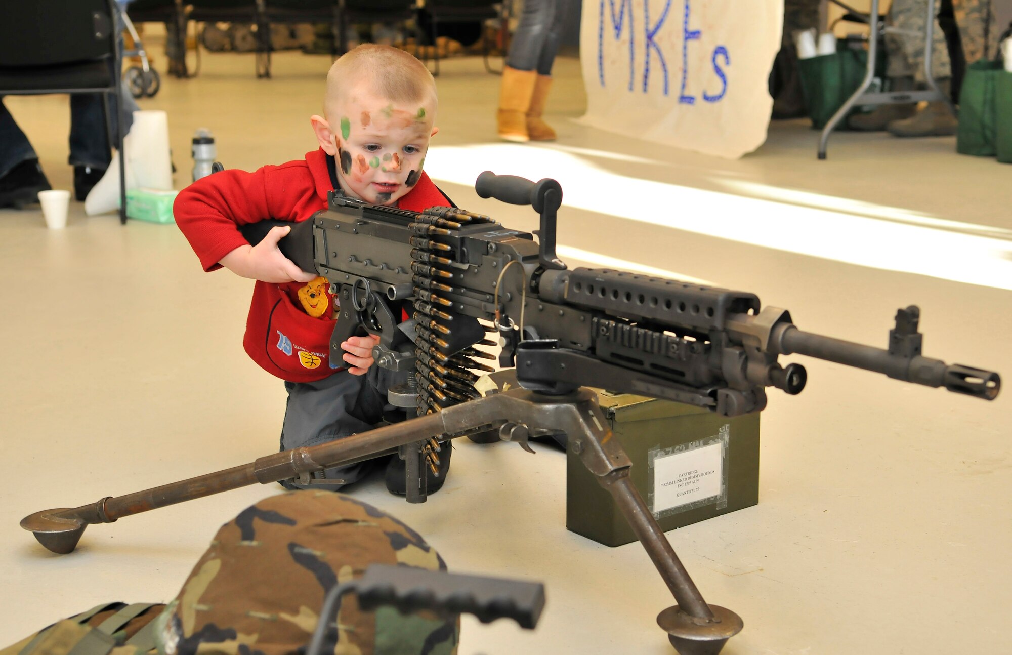 Elijah Eddy gets an up-close look at an M-249 during Operation Bug Out at the Joint Mobility Center Mar. 12, 2010, Eielson Air Force Base, Alaska. Operation Bug Out is a venue for children to experience what is like for their loved one to deploy. Elijah's mother, Airman 1st Class Brittney Ferriera, is assigned to the 354th Maintenance Squadron. (U.S. Air Force photo/Staff Sgt. Christopher Boitz)