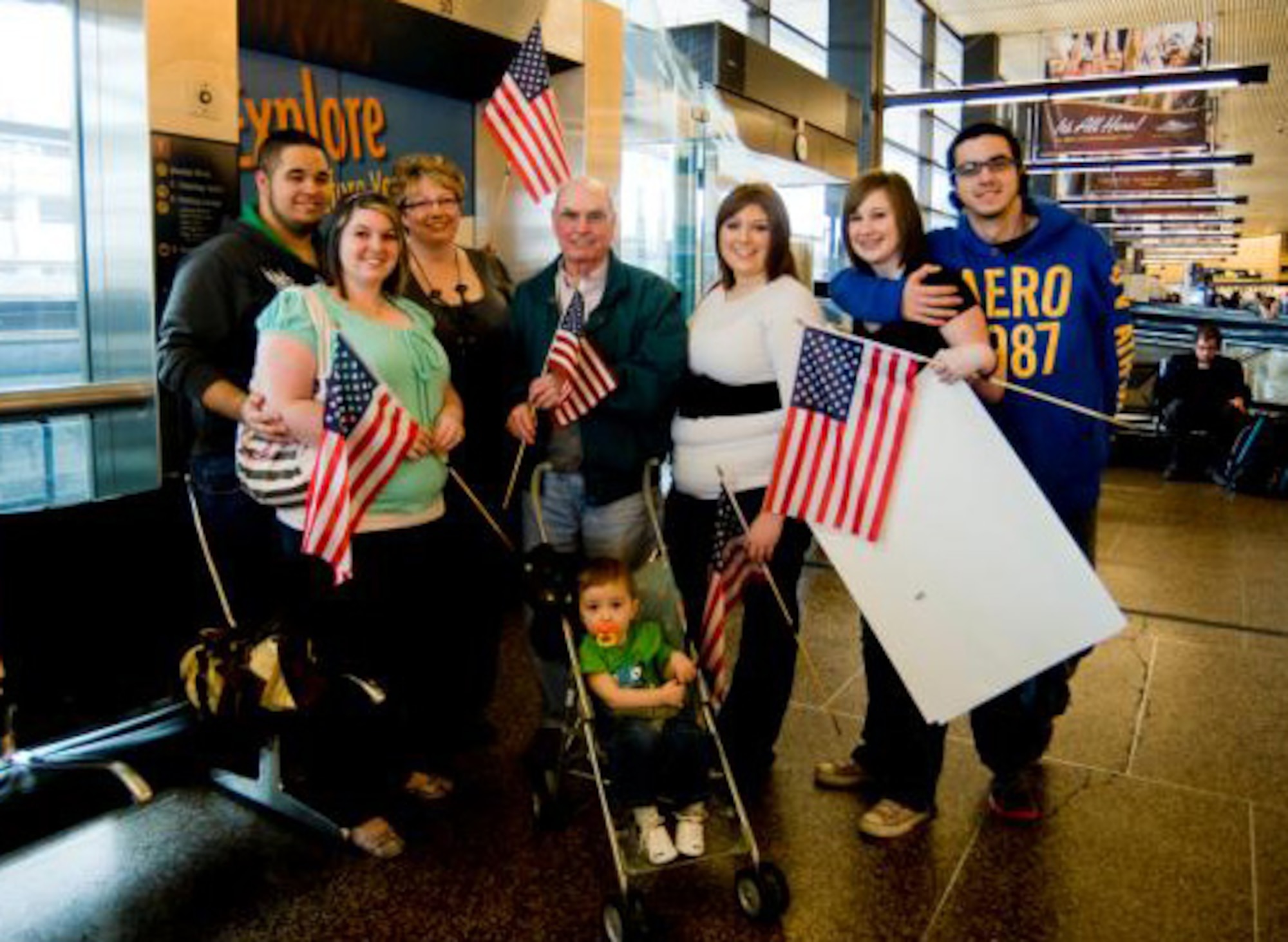SEATTLE- The family of Senior Master Sgt. Cliff Petheram, a Reservist with the 446th Civil Engineer Squadron, Joint Base Lewis-McChord, Wash., awaits his arrival at the Seattle-Tacoma International Airport here, March 15. Sergeant Petheram is one of about 30 Reservists from the 446th CES who returned March 15 from a six-month deployment to Kirkuk Regional Air Base, Iraq. (U.S. Air Force photo/Abner Guzman)