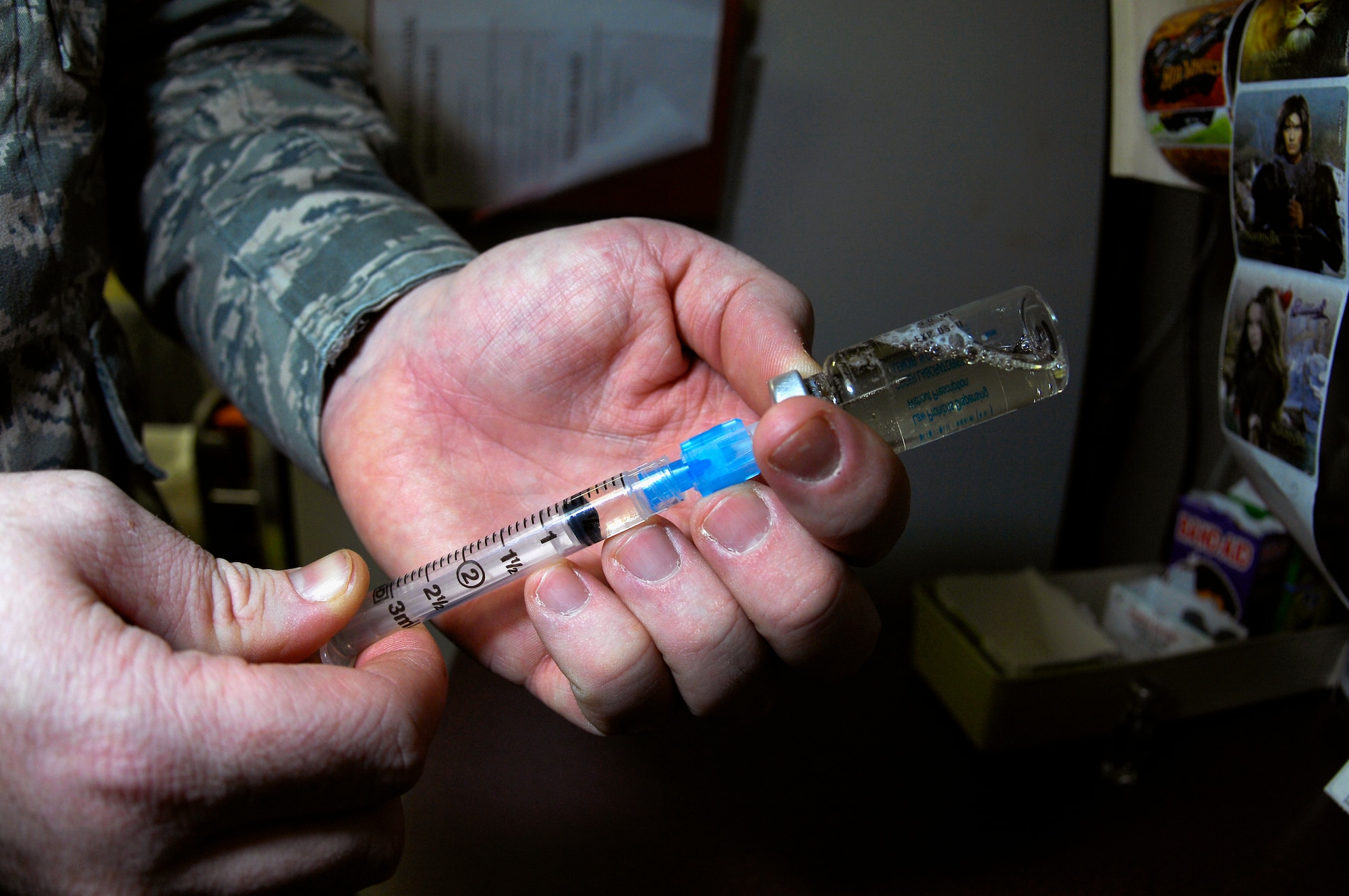MINOT AIR FORCE BASE, N.D. -- Staff Sgt. Christopher Brown, 5th Medical Operations Squadron allergy and immunizations technician, mixes an intramuscular shot for a patient at the Allergy and Immunizations Clinic in the 5th Medical Group March 11. A typical intramuscular shot may include anthrax, typhoid or tetnis. (U.S. Air Force photo by Senior Airman Benjamin Stratton)