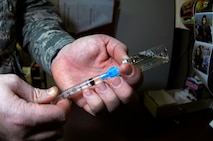 MINOT AIR FORCE BASE, N.D. -- Staff Sgt. Christopher Brown, 5th Medical Operations Squadron allergy and immunizations technician, mixes an intramuscular shot for a patient at the Allergy and Immunizations Clinic in the 5th Medical Group March 11. A typical intramuscular shot may include anthrax, typhoid or tetnis. (U.S. Air Force photo by Senior Airman Benjamin Stratton)