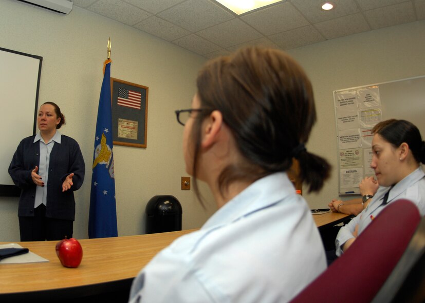 MINOT AIR FORCE BASE, N.D. -- Tech. Sgt. Janie Rodriguez, First Term Airmen Center noncommissioned officer-in-charge, discusses force protection with first term Airmen at the Professional Development Center at Minot Air Force base Feb. 7. FTAC classes help new Airmen prepare for a successful Air Force career. (U.S. Air Force photo by Airman 1st Class Ashley N. Avecilla) 