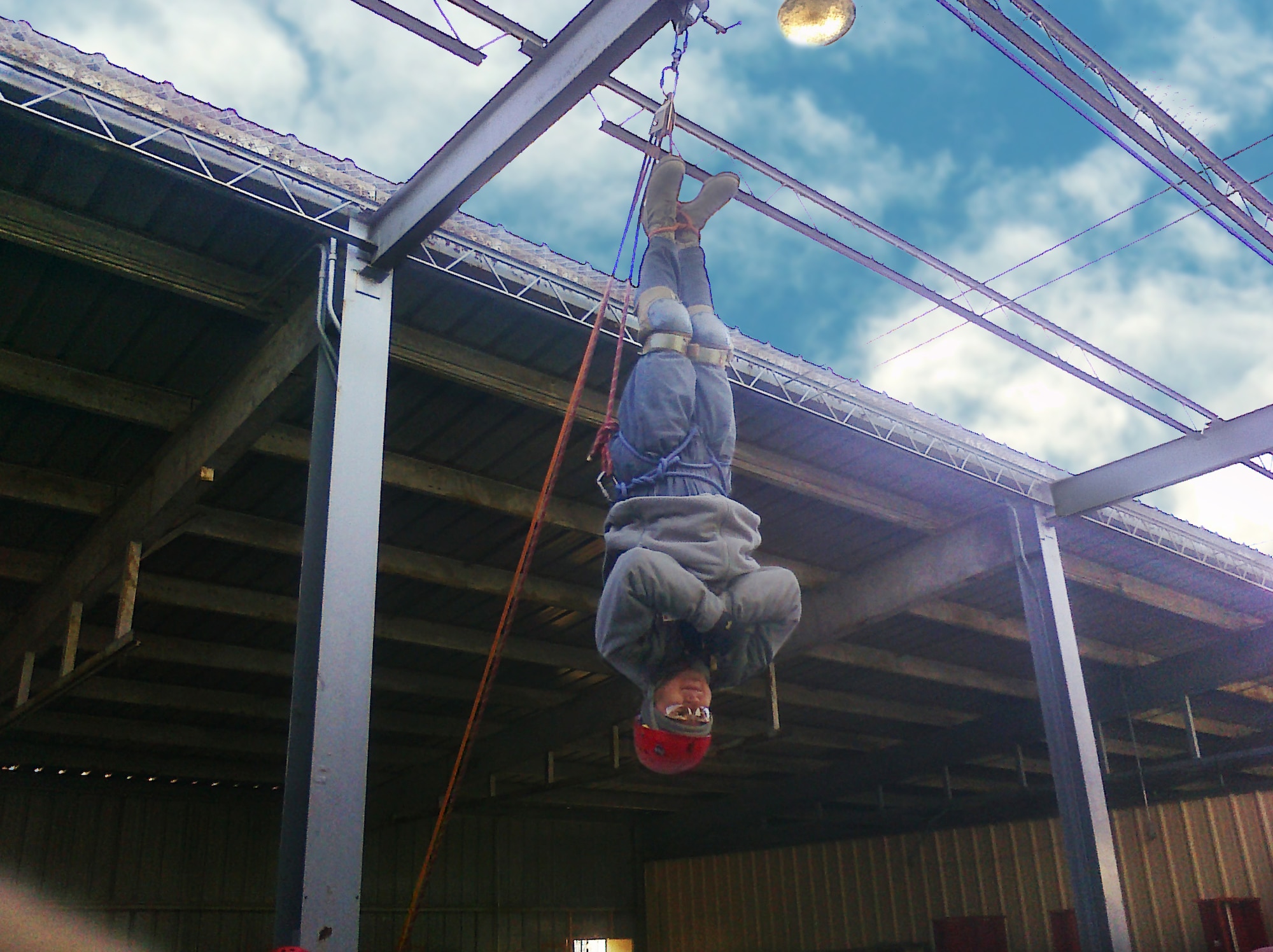 Staff Sgt. Cesar Valverde, Health Physics Technician, USAFSAM, Radiation Health Consulting (OEHH), hangs upside down on a rappelling tower, supported by rescue knots he tied himself. Staff Sgt. Valverde participated in the U.S. Marine Corps’ Chemical Biological Incident Response Force Basic Operations Course.