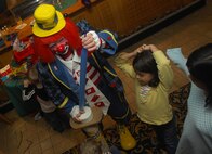 MINOT AIR FORCE BASE, N.D. -- A balloon animal takes shape as Dizzy fulfills requests by kids at the Jimmy Doolittle Center March 14. Dizzy appears at every Sunday brunch at J.R. Rockers for family night, along with many public appearances for the Shriners. (U.S. Air Force photo by Laurie Arellano)