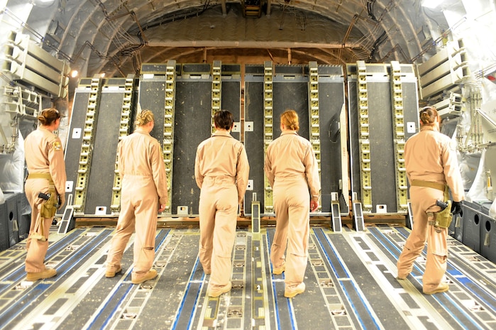 Airmen wait for the ramp to go down on a C-17 Globemaster III as they prepare for a cargo load at a non-disclosed Southwest Asia location March 10, 2010. The Airmen were on board a flight featuring an all-female crew in honor of Women's History Month. From left to right, 1st Lt. Erica McCaslin, pilot; Capt. Alicia Dittus, pilot; Capt. Sarah Burdon, intelligence officer in-charge, Master Sgt. Lisa Peele, first sergeant, and Senior Airman Christine Collier, loadmaster, all from the 816th Expeditionary Airlift Squadron and deployed from the 14th Airlift Squadron. (U.S. Air Force photo by Senior Airman Kasey Zickmund)
