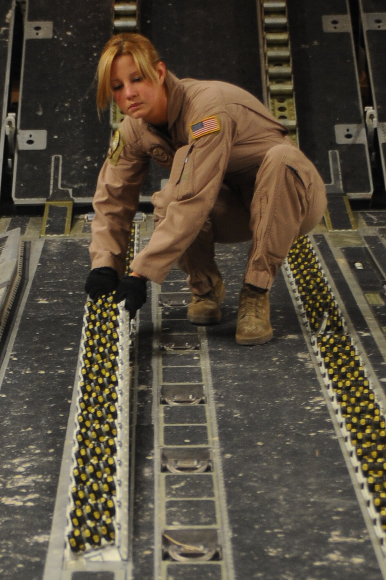 Senior Airman Spencer Keeley, 816th Expeditionary Airlift Squadron loadmaster, prepares a C-17 Globemaster III to receive pallets at a non-disclosed Southwest Asia location March 10, 2010. Airman Spencer was part of an all-female crew in honor of Women's History Month and is deployed from the 14th Airlift Squadron. (U.S. Air Force photo by Senior Airman Kasey Zickmund)
