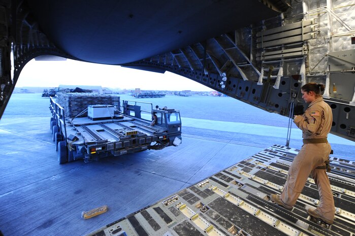 Senior Airman Christine Collier, 816th Expeditionary Airlift Squadron loadmaster, approaches a loader with pallets to board a C-17 Globemaster III at a non-disclosed Southwest Asia location March 10, 2010.  Airman Collier was part of an all-female crew in honor of Women's History Month and is deployed from the 14th Airlift Squadron. (U.S. Air Force photo by Senior Airman Kasey Zickmund)