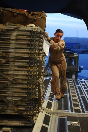 First Lt. Erica McCaslin, 816th Expeditionary Airlift Squadron pilot, pushes a pallet onto a C-17 Globemaster III for shipment at a non-disclosed Southwest Asia location March 10, 2010. Lieutenant McCaslin was part of an all-female crew in honor of Women's History Month and is deployed from the 14th Airlift Squadron. (U.S. Air Force photo by Senior Airman Kasey Zickmund)