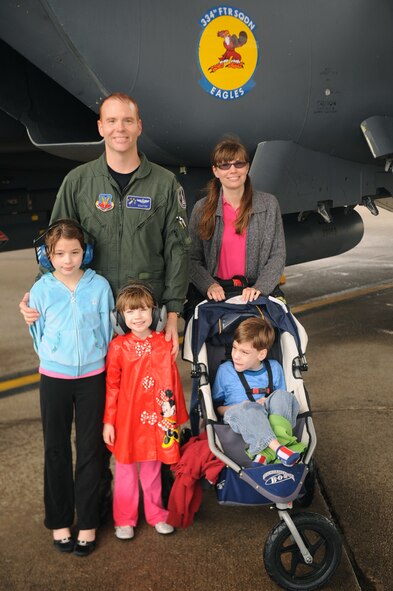 Lt. Col. Jason Brenneman, 4th Operations Support Squadron operations flight commander, takes a moment with his wife, Lisa, and children, Alyssa, 8, Marlena, 4, and Joshua, 6, to commemorate his final flight in the F-15E Strike Eagle on Seymour Johnson Air Force Base, N.C., March 12, 2010. Brenneman is leaving Seymour Johnson to serve as the airfield director of operations at the Air Force Academy in Colorado. Brenneman hails from Lexington, Mo. (U.S. Air Force photo/Senior Airman Ciara Wymbs) 