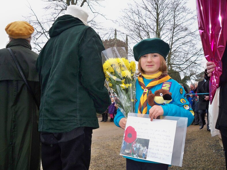Freedom Scott, age 7, prepares to present the Queen a poppy flower he made and a picture of their previous visit during Christmas Feb. 7. Freedom Scott is the son of Major Dennis and Peg Tansley. Major Tansley is assigned to the 423rd Medical Squadron. (Courtesy of Tansley Family)