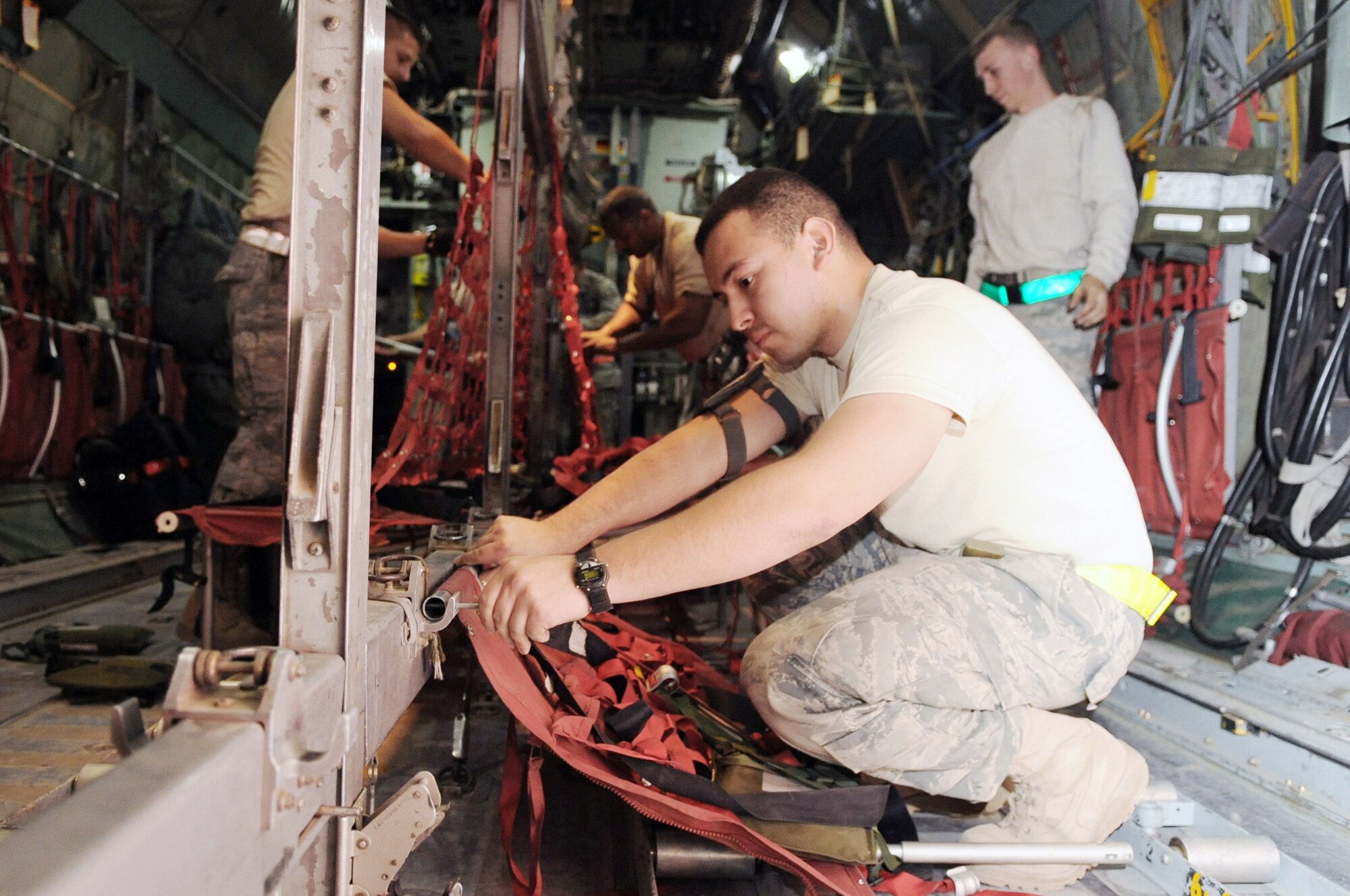 Airmen from the 777th Expeditionary Aircraft Maintenance Unit put seats in a C-130E Hercules to prepare for its last combat mission March 6, 2010, at Joint Base Balad, Iraq. (U.S. Air Force photo/Senior Airman Brittany Y. Bateman)