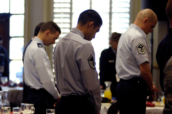Members of Team Charleston bow their heads in prayer during the National Prayer Breakfast held in the Charleston Club March 15. Originally called the Presidential Prayer Breakfast, the name was changed to the National Prayer Breakfast in 1970. During the breakfast numerous speakers read selections from Hebrew scripture as well as the Bible. (U.S. Air Force photo/Airman 1st Lauren Main)