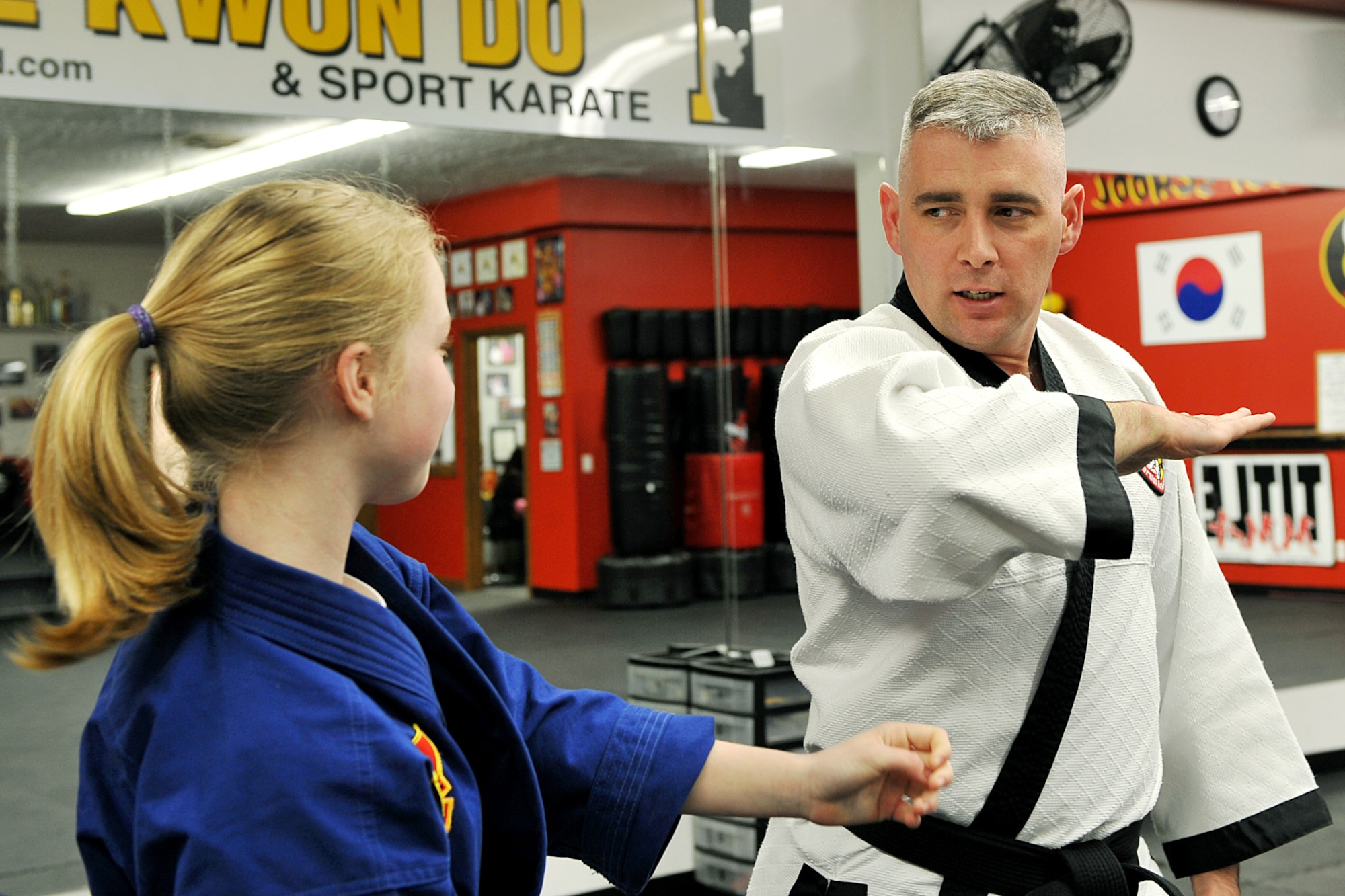 OFFUTT AIR FORCE BASE, Neb. - Abby Wolfe attempts to grab the wrist of Tech. Sgt. Michael Munyon, with the 55th Security Forces Sqaudron, during hapkido class at an Omaha dojang March 12. Sergeant Munyon currently holds a 5th degree black belt in Taekwondo and a 2nd degree black belt in Hapkido, another form of Korean martial arts. He was recently inducted into the Masters Hall of Fame.

U.S. Air Force Photo by Charles Haymond