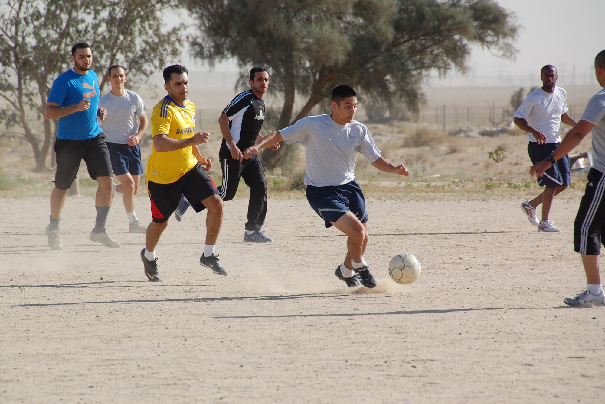 U.S. Air Force Senior Airman Peter Dominguez breaks from the defense during a soccer match March 16, 2010 at an air base in Southwest Asia. The 386th Air Expeditionary Wing beat the host nation base team 3-0. (U.S. Air Force photo by Staff Sgt. Lindsey Maurice/Released)