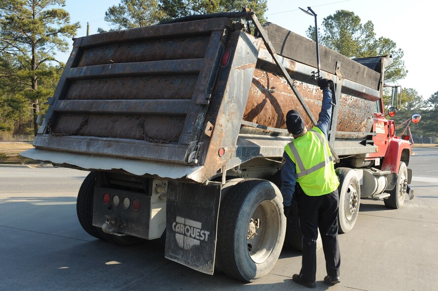 Louis Bechel, Southeastern Protective Services security officer, uses a mirror to search the back of a truck for suspicious looking objects before granting it entry into Seymour Johnson Air Force Base, N.C., March 9, 2010. Southeastern Protective Services assist 4th Security Forces Squadron with protecting base assets and personnel. Bechel is from Pikeville, N.C. (U.S. Air Force photo/Senior Airman Whitney Lambert)