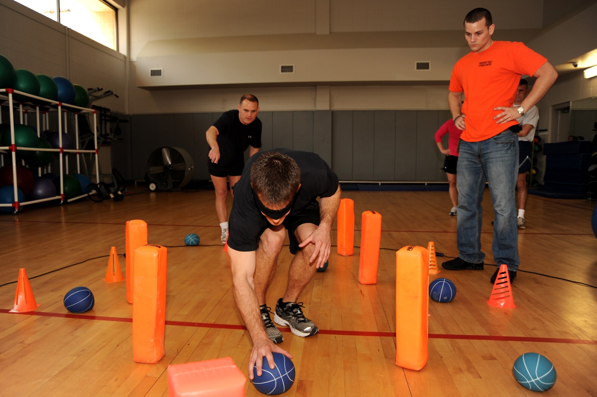 Airmen navigate the mystery event blindfolded while being guided by their team leader during the 19th Annual Fit Eagle Competition March 12th, Hurlburt Field, Fla.  Nine squadrons and more than 50 Airmen competed for the title of Hurlburt Field’s best in shape  during the competition held at the Aderholt Fitness Center(U.S. Air Force photo by Senior Airman Matthew Loken)
