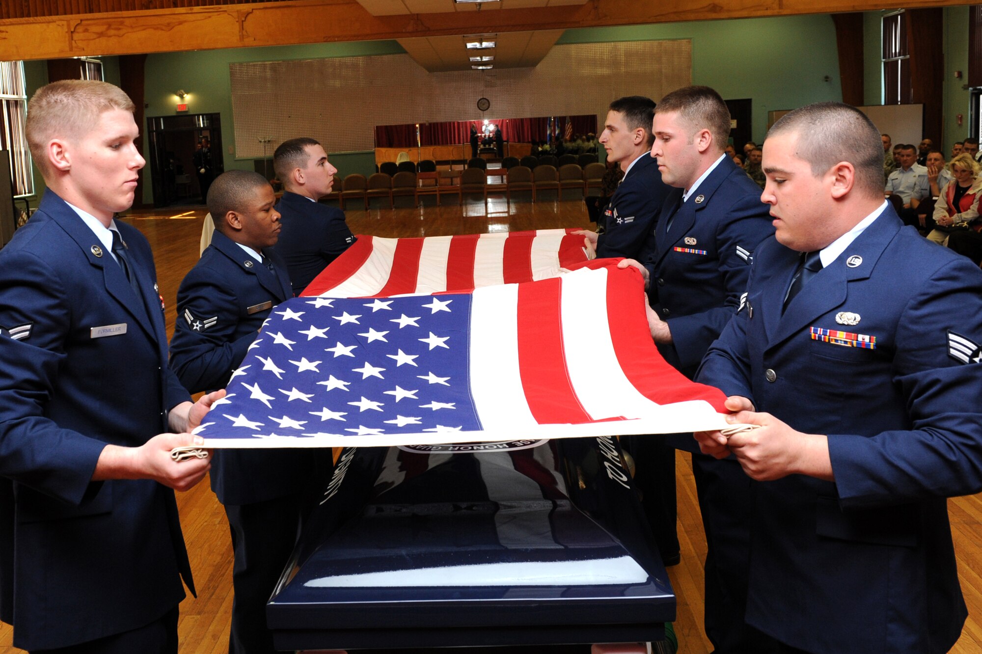 The newest members of the 19th Airlift Wing Honor Guard prepare to fold the U.S. Flag during their graduation ceremony March 8 at the Thomas Community and Activities Center. The Little Rock Air Force Base Honor Guard's mission is to provide military honors for deserving veterans, retirees, active duty, Guard and Reserve members on base, in Arkansas and the surrounding area on behalf of the president of the United States, the department of the Air Force and a grateful nation. (U.S. Air Force photo by Senior Airman Ethan Morgan)