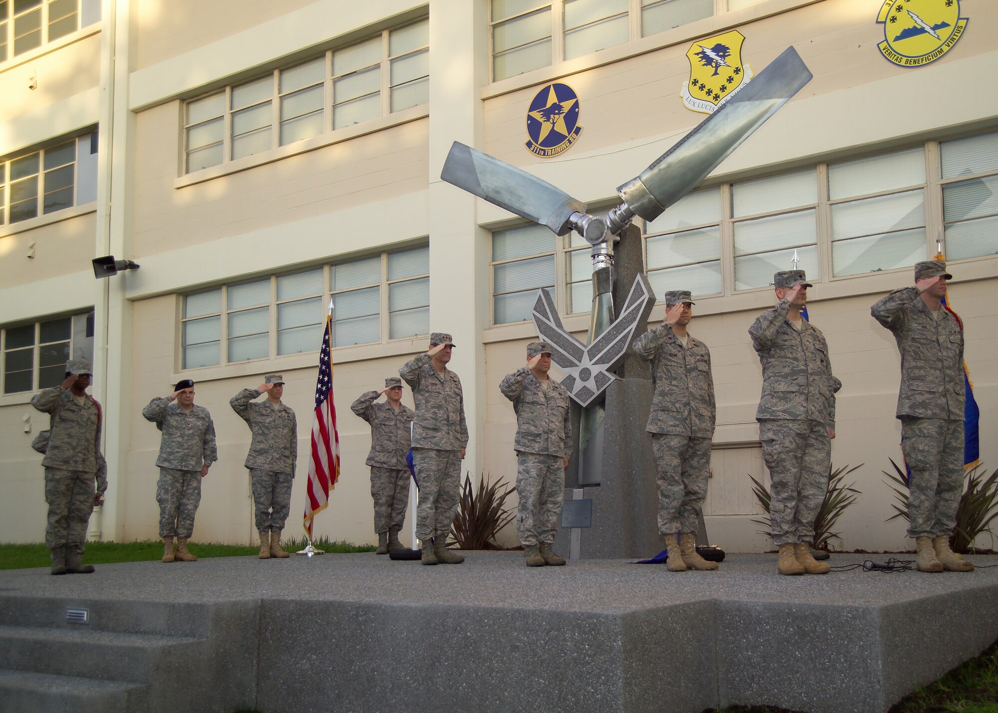 Gen. Stephen Lorenz, Air Education and Training Command commander and Airmen of the 517th Training Group offer a salute during reveille at the dedication of the Presidio of Monterey’s new Airman Heritage Exhibit. The exhibit was designed as a tribute to Air Force cryptologic linguists who have fallen in the line of duty, spanning from 1953 over the Sea of Japan through the most recent in 2005 in Albania. (U.S. Air Force photo)