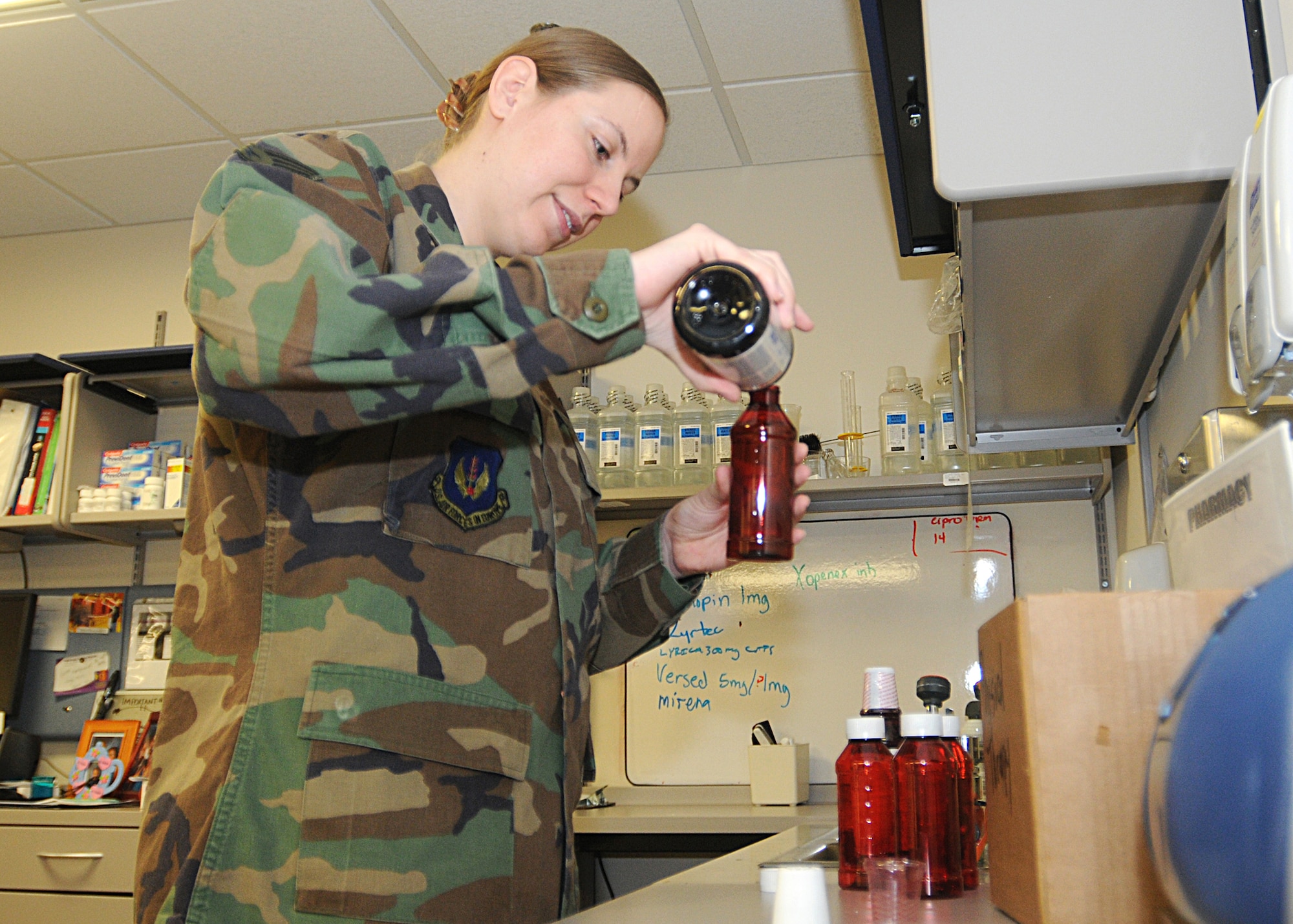 Senior Airman Melissa Guzman, 31st Medical Support Squadron, fills a pre-package prescription bottle with antiseptic mouthwash at the Aviano pharmacy March 11, 2010.  Pre-packaging commonly ordered prescriptions streamlines the filling process, allowing patients to receive their prescriptions faster.  (U.S. Air Force photo/Senior Airman Tabitha M. Mans)