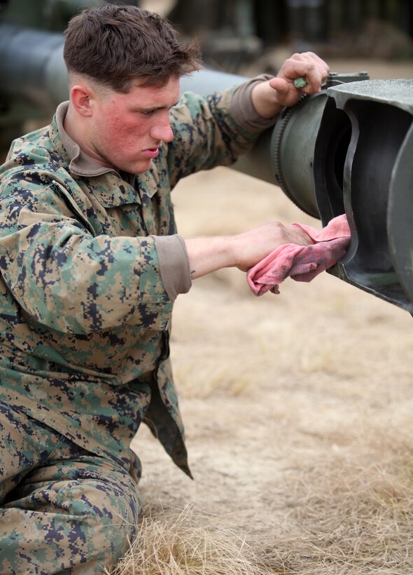 Lance Cpl. Jay J. Wemlinger, a canoneer with 2nd Battalion, 10th Marine Regiment, 2nd Marine Division, cleans the barrel of an M777 Light Towed Howitzer during a month-long regimental field exercise called Rolling Thunder, aboard Fort Bragg, March 18, 2010. Regular maintenance is performed on the howitzers to ensure they remain in good working condition.