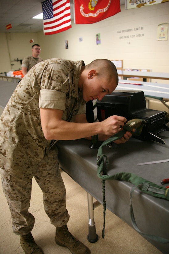 Lance Cpl. Jacob W. Grohman, a flight equipment technician with Marine Aviation Logistics Squadron 14’s aviation life support system section, makes the final repairs on a parachute. Parachute riggers spend anywhere from four hours to a full day repairing parachutes for the squadrons of 2nd Marine Aircraft Wing.