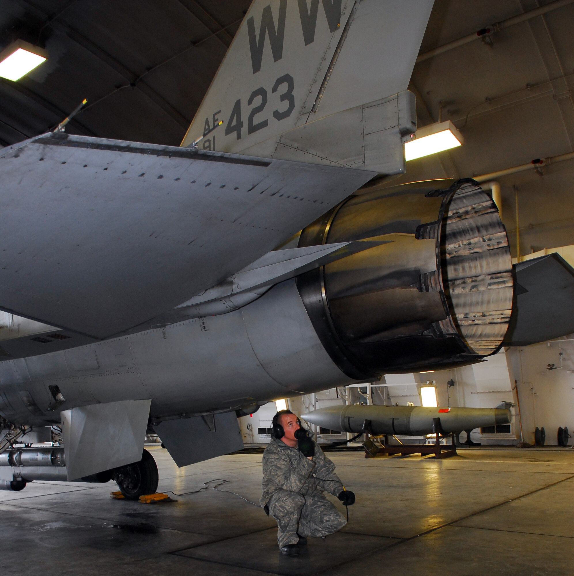 MISAWA AIR BASE, Japan – Staff Sgt. Donald Slayton, 13th Aircraft Maintenance Unit dedicated-crewchief, talks Maj. Dylan Baumgartner, 35th Fighter Wing chief of wing inspections, through a flight control operational checkout March 16 in a hardened aircraft shelter. The flight control operational check is part of a checklist that the pilot follows prior to taxiing for his mission. (U.S. Air Force photo/Staff Sgt. Phillip Butterfield)