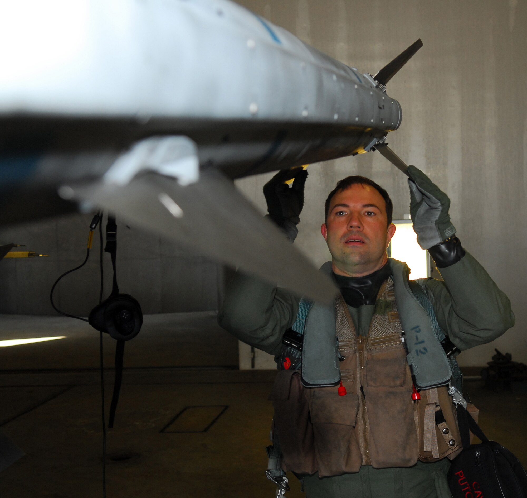 MISAWA AIR BASE, Japan – Maj. Dylan Baumgartner, 35th Fighter Wing chief of wing inspections, inspects an AIM 120 air-to-air missile prior to his training sortie March 16 in a hardened aircraft shelter. Major Baumgartner, like all pilots, performs a walk around of the aircraft looking for any discrepancies prior to launching. (U.S. Air Force photo/Staff Sgt. Phillip Butterfield)