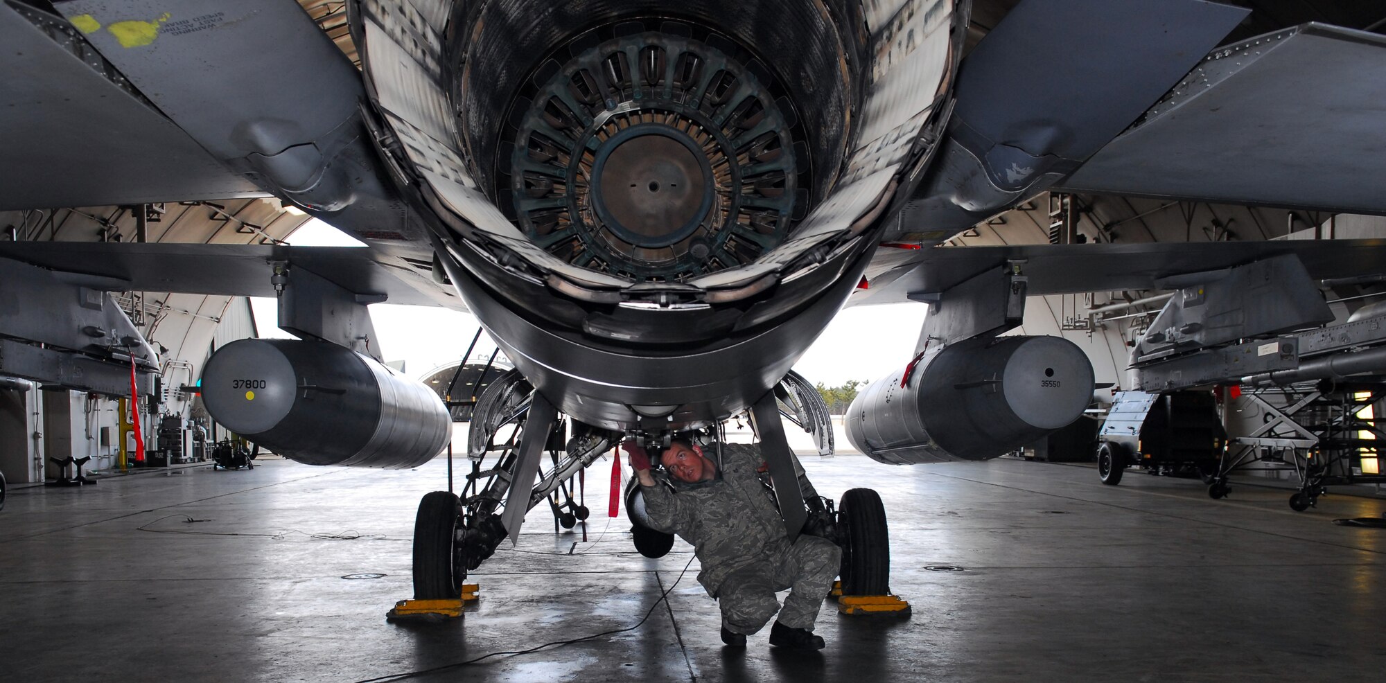 MISAWA AIR BASE, Japan – Staff Sgt. Donald Slayton, 13th Aircraft Maintenance Unit dedicated-crewchief, wipes down his aircraft prior to launch March 16 in a hardened aircraft shelter. Sergeant Slayton, a native of Gainesville, Fla., has been enlisted for nine years and is the DCC for aircraft 423. (U.S. Air Force photo/Staff Sgt. Phillip Butterfield)
