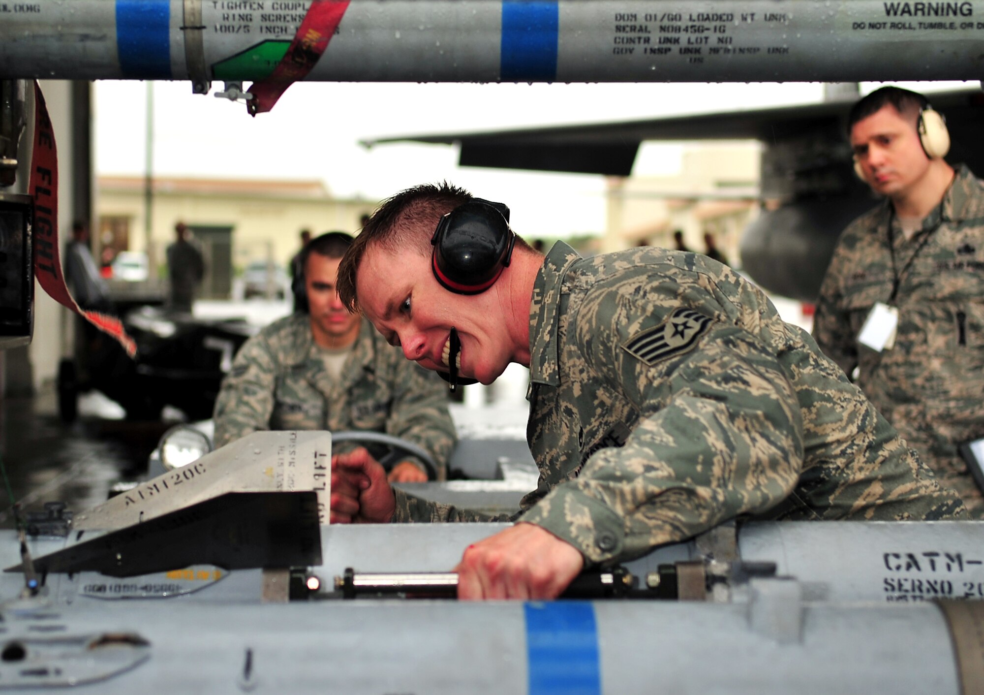 Staff Sgt. Michael Clark, 18th Aircraft Maintenance Squadron weapons crew chief, checks to make sure that an AIM-9 missile is ready to be lifted and attached to the wing of an F-15 Eagle during the Turkey Shoot 2010 at Kadena Air Base, Japan, March 9. The Turkey Shoot is an annual internal competition intended to sharpen operational capabilities and assign bragging rights. (U.S. Air Force photo/Tech. Sgt. Rey Ramon)                      