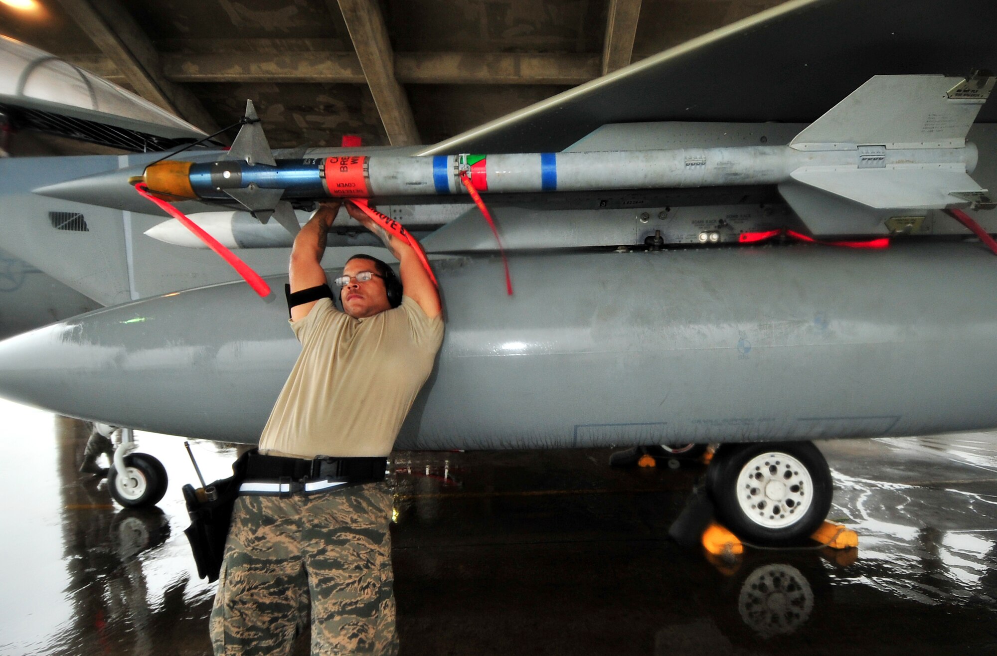 Airman 1st Class Darrel Evans, 18th Aircraft Maintenance Squadron, connects the umbilical adapter on an AIM-9 missile during the Turkey Shoot 2010 at Kadena Air Base, Japan, March 9.  
(U.S. Air Force photo/Tech. Sgt. Rey Ramon)                               