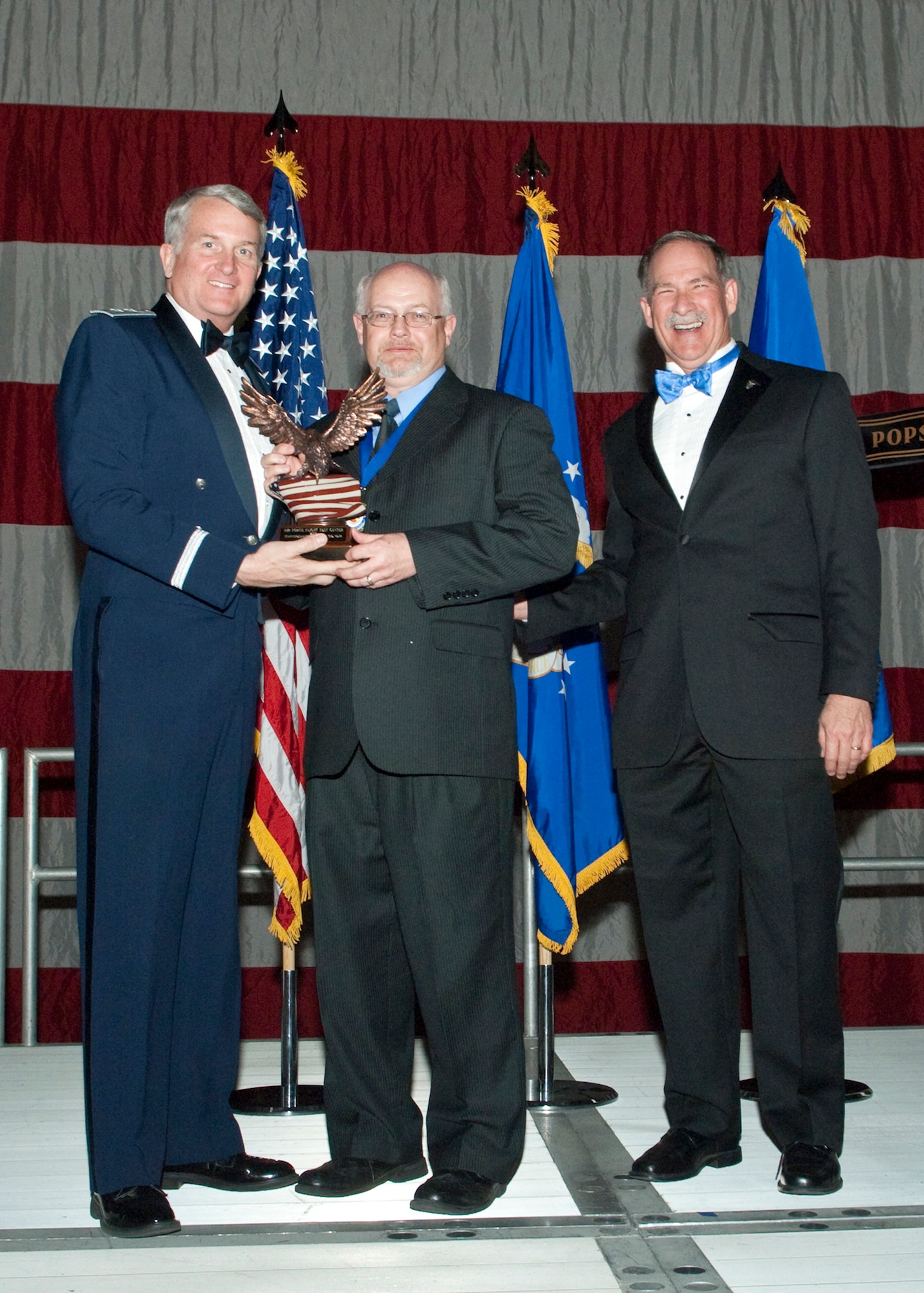 Dennis J. Collins, 452nd Flight Test Squadron Global Hawk deputy for Logistics, receives the Specialist and Analyst Civilian of the Year Award during the Air Force Flight Test Center Annual Awards ceremony March 12. (Air Force photo/Mike Yncera)