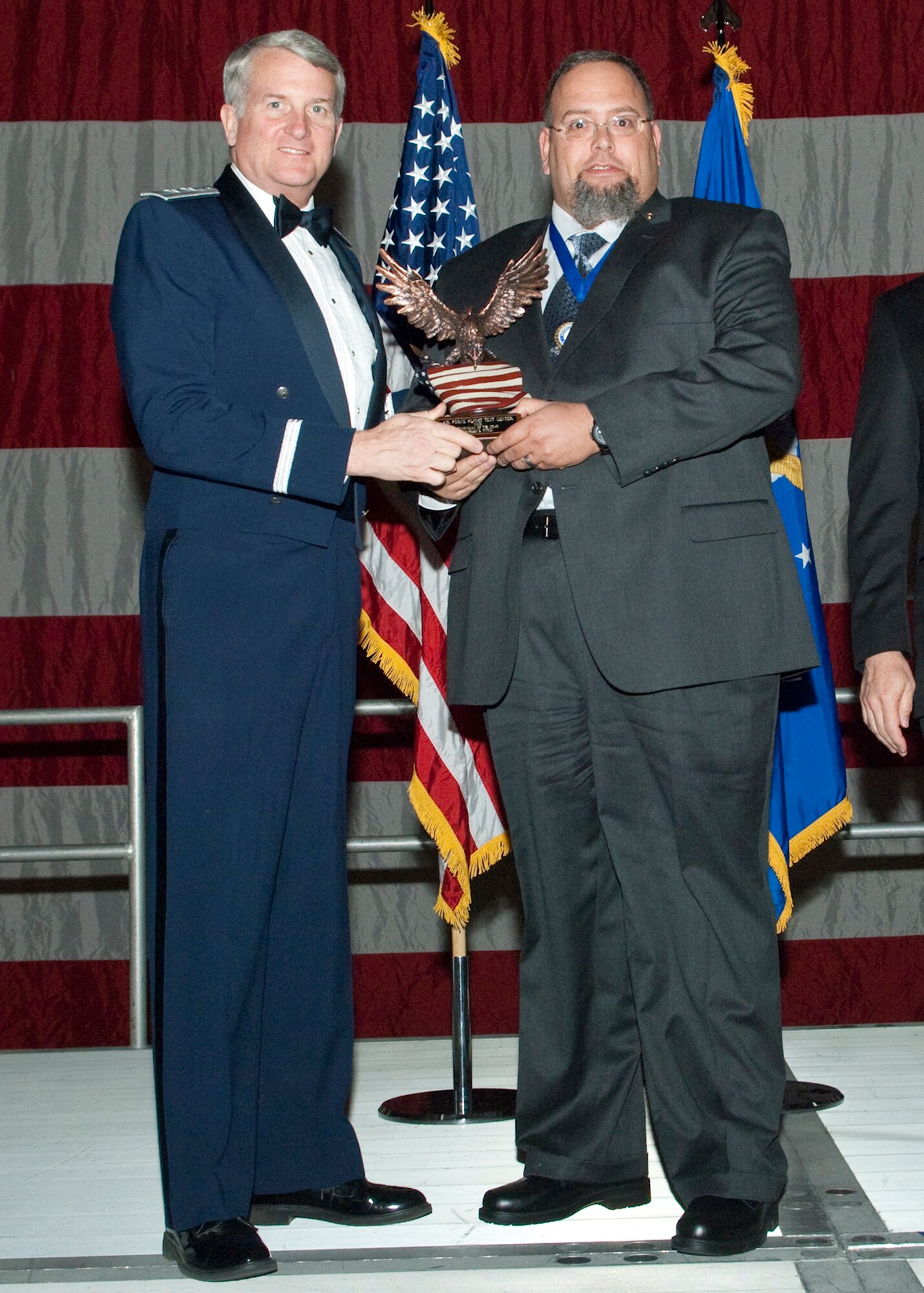 Charles E. Tyson, 412th Maintenance Squadron Munitions Plans and Programs monitor, receives the Technician Civilian of the Year Award during the Air Force Flight Test Center Annual Awards ceremony March 12. (Air Force photo/Mike Yncera)