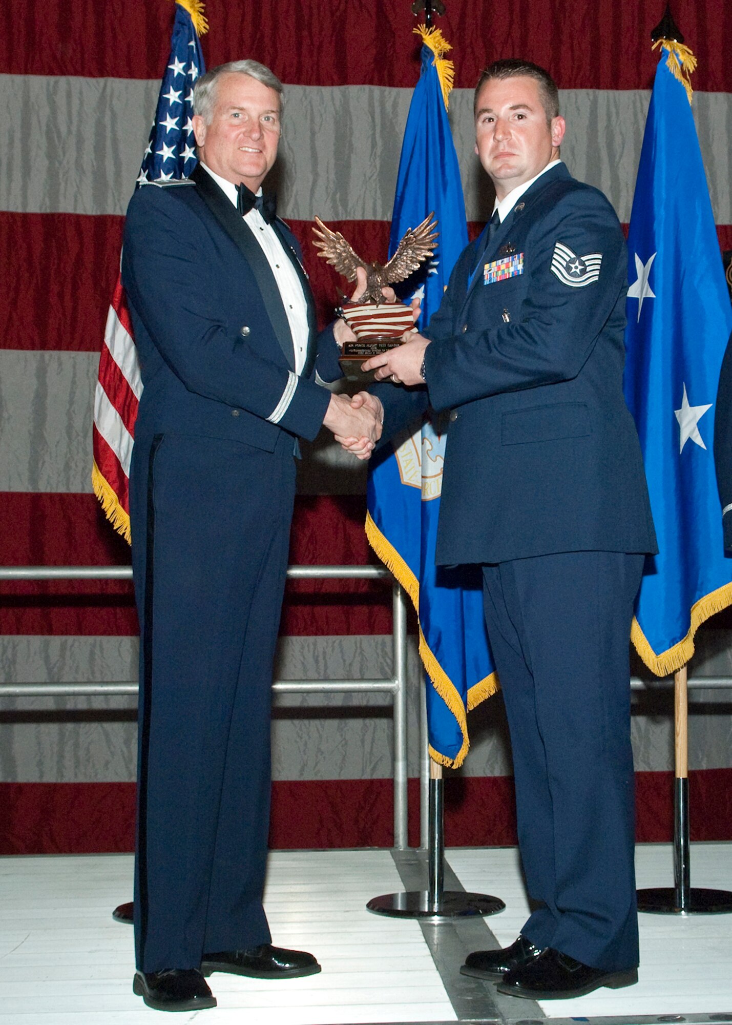 Tech. Sgt. Brian Freeland, 412th Maintenance Group Loading Standardization crew member, receives the Noncommissioned Officer of the Year during the Air Force Flight Test Center Annual Awards ceremony March 12. (Air Force photo/Mike Yncera)