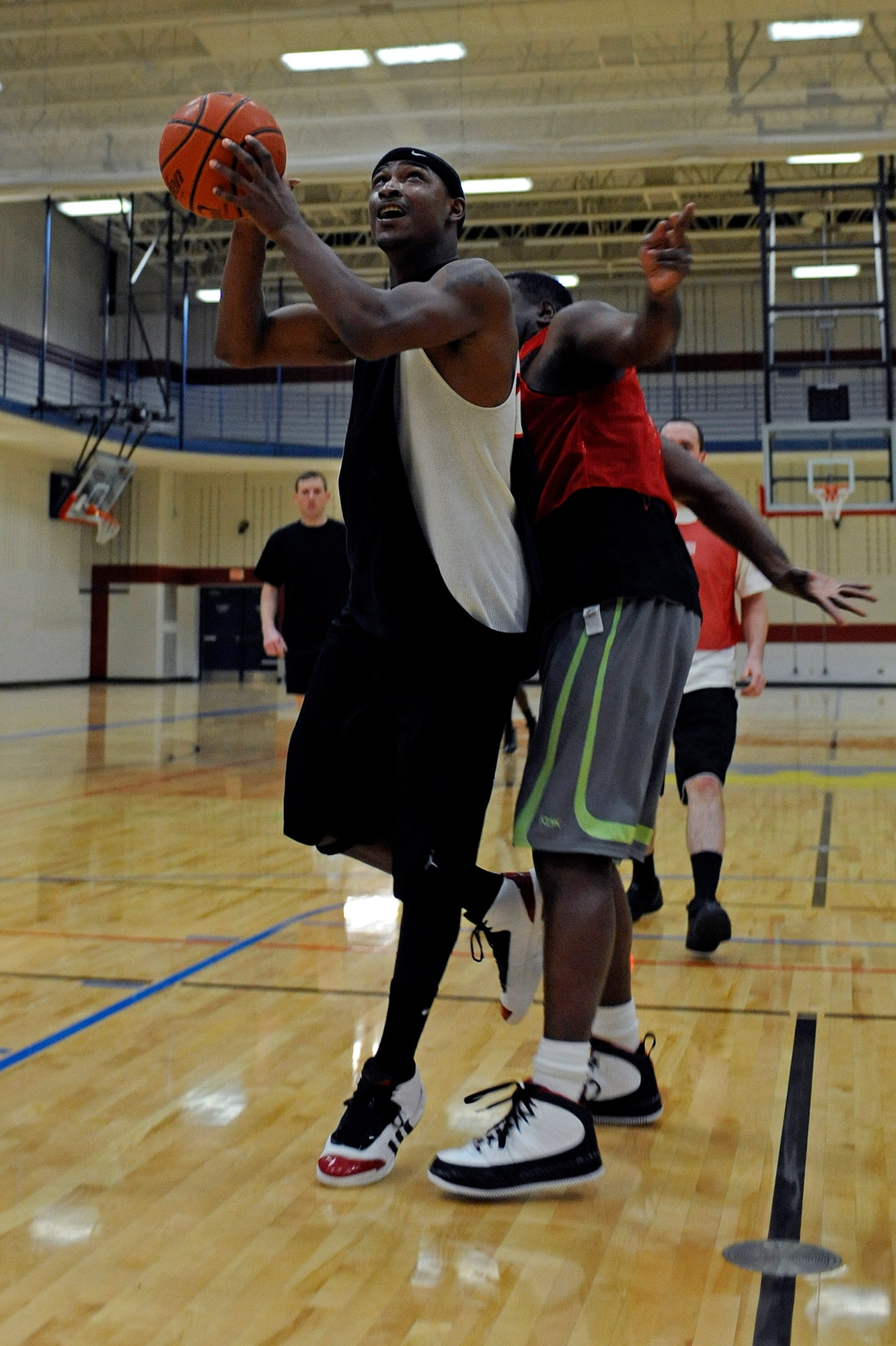 ELLSWORTH AIR FORCE BASE, S.D. – (Left to right) Airman 1st Class Dan Goodson, 28th Operations Support Squadron communications security technician, attempts a shot against Senior Master Sgt. Dobie Strong, 28th Logistics Readiness Squadron deployment and distribution flight chief, during Ellsworth's intramural basketball championship game, March 16. The game featured a match-up between the 28th Operations Group and the 28th Logistics Readiness Squadron. (U.S. Air Force photo/Airman 1st Class Matthew Flynn)