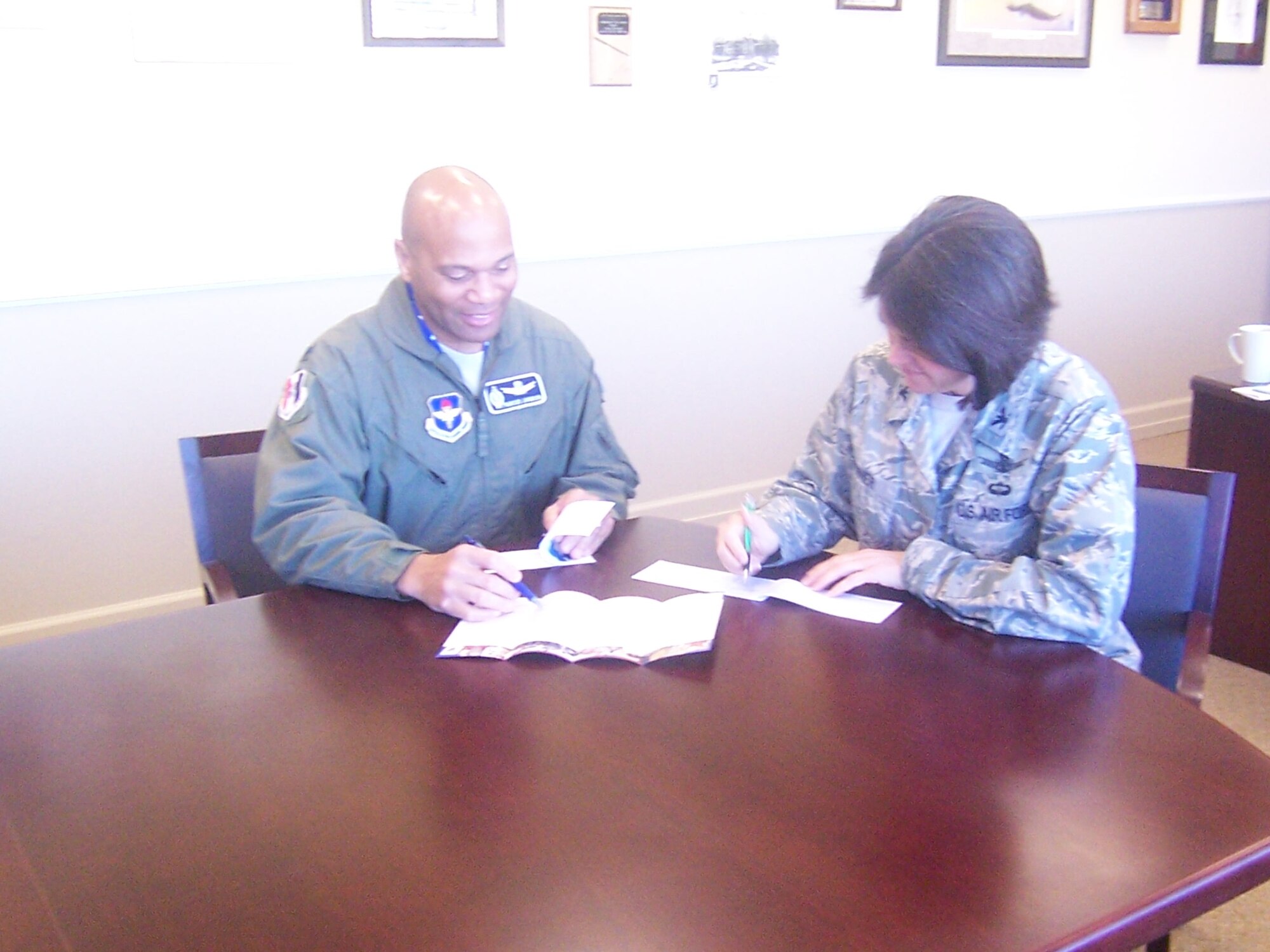 VANDENBERG AIR FORCE BASE, Calif. -- Col. Stella Renner, the 381st Training Group commander,  and Lt. Col. Marcus Johnson, the 381st TRG deputy commander, make donations to the Air Force Assistance Fund campaign here Friday, March 12, 2010. The 381st TRG has raised $11,000 after one week of campaigning. (U.S. Air Force photo/Capt. Jeffrey Parrish)