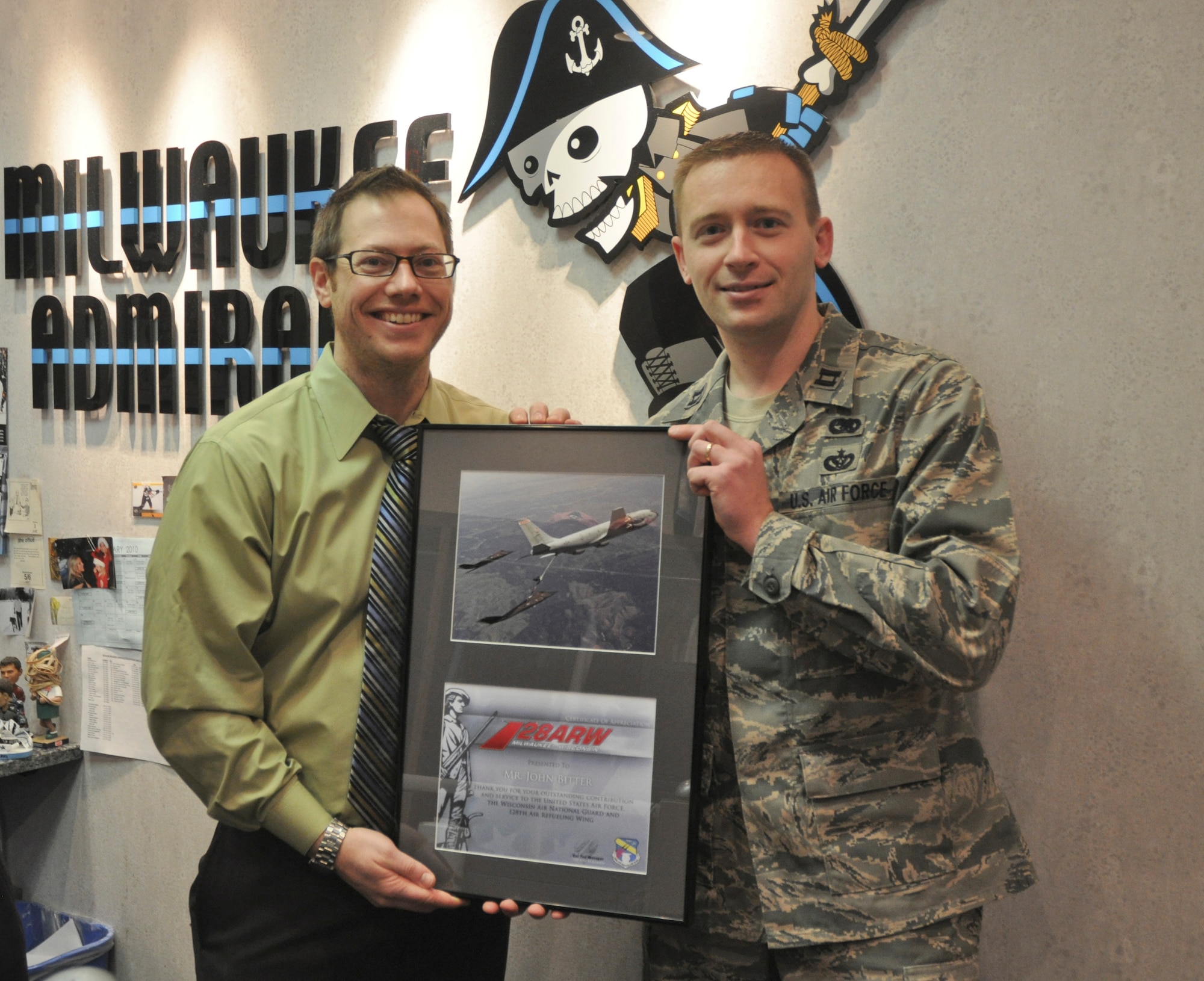 Capt. Aaron Gulczynski presents a certificate of appreciation to Mr. John Bitter of the Milwaukee Admirals.  Mr. Bitter is the group ticket sales manager for the Admirals and for the past 3 years has supported the Wing with discounted tickets and great seats close to the ice.   The 128th had its annual hockey night on January 22nd against the Chicago Wolves with 83 tickets spoken for by members of the wing.  