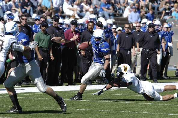 Falcon wide receiver Chad Hall avoids a tackle during a 2007 game against the University of Wyoming. During this game, Hall rushed 28 times for 167 yards and had two returns for 28 yards. He also caught a four-yard touchdown pass that helped the Falcons win the game, 20-12. (U.S. Air Force photo by John Van Winkle.)
