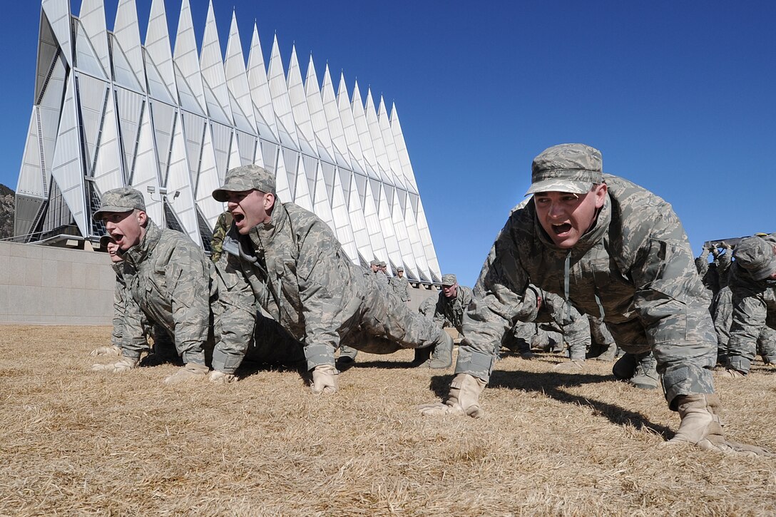Cadet freshmen Matthew Schuetz, Caleb Belden, and William Hicks of Cadet Squadron 18 recite information about the F-15 Eagle while performing push-ups during Recognition at the U.S. Air Force Academy, Colo.,  March 12, 2010.  Recognition is the final event before the freshmen cadets are welcomed into the ranks of the upper class cadets. (U.S. Air Force photo/Rachel Boettcher)