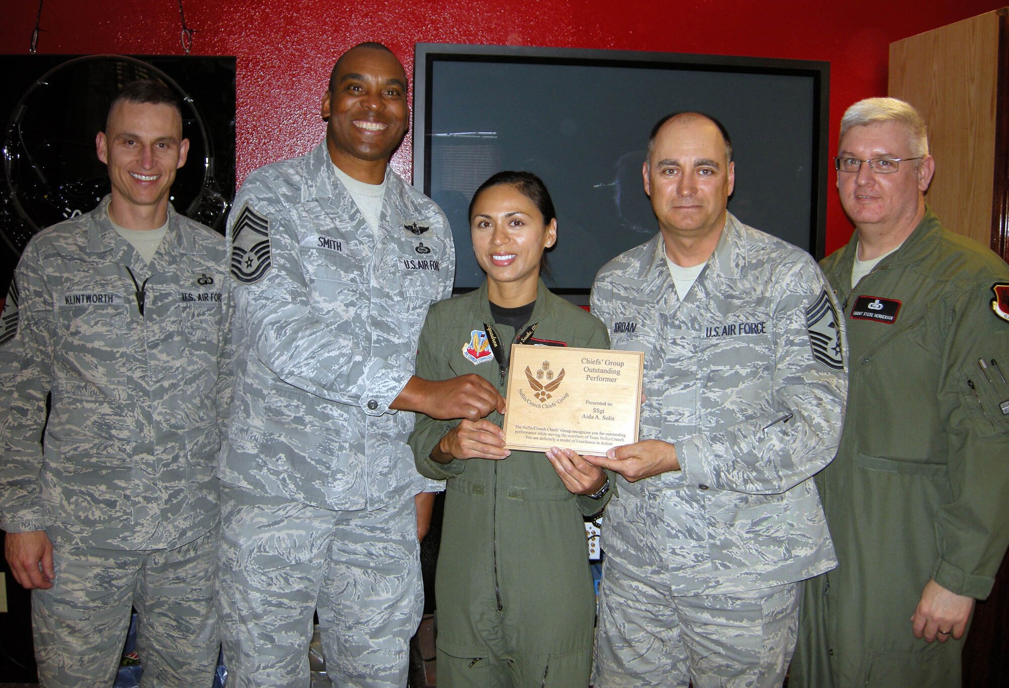 Staff Sgt. Solis (center), received an Excellence in Action award March 3. The award is presented monthly by the Chief's Group to deserving Airmen who have gone above and beyond the normal call of duty. (U.S. Air Force photo/Staff Sgt. Alice Moore)
