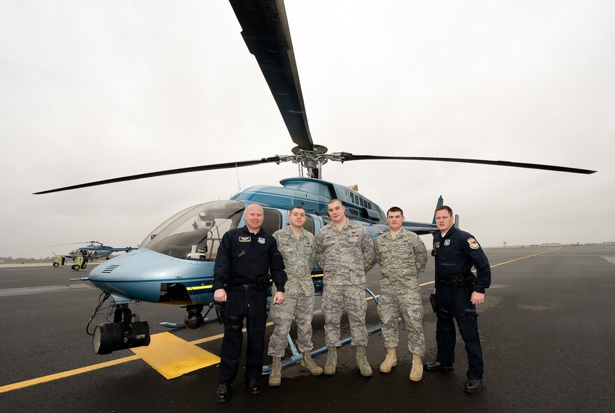 Members of Team Dover's air traffic control unit pose for a photo before they take off on their incentive flight in the Bell 407 Helicopter. This event was enacted in the desire to see greater teamwork between the Delaware State Police's Aviation unit and Dover's air traffic controllers.(U.S. Air Force photo/Jason Minto)