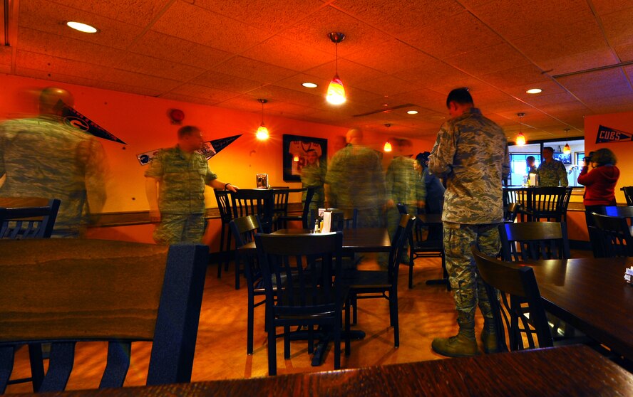 OFFUTT AIR FORCE BASE, Neb.- Following a ribbon cutting ceremony, 55th Wing senior leaders walk through  the new sports lounge in the Ronald. L. King Dining Facility here March 16.  The sports lounge addition to the facility was funded using money awarded to Offutt after winning the Air Combat Command Hennessey Award for outstanding dining facility. U.S. Air Force photo by Josh Plueger

