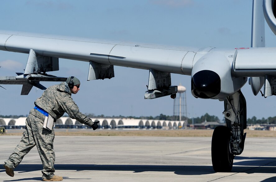 MOODY AIR FORCE BASE, Ga. -- Staff Sgt. Joseph McMillan, 23rd Aircraft Maintenance Squadron weapons load crew member, gives a thumbs up to his fellow Airmen helping with a final inspection before takeoff. A crew consists of two crew chiefs and two weapons load crew members removing lock pins, tire blocks and arming the jet’s weapons, as well as ensuring there are no safety issues with the aircraft. (U.S. Air Force photo by Airman 1st Class Joshua Green)