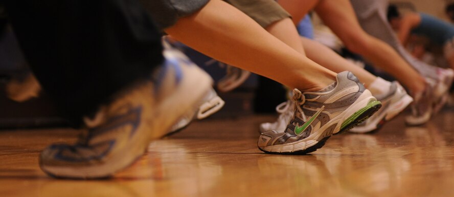 MOODY AIR FORCE BASE, Ga. -- Participants in the Mommy Boot Camp class run in place against the bleachers during the class here March 11. The group did three alternate sets of running in place and stair climbs on the bleachers, one of the ways the mothers burn calories during the workout session. (U.S. Air Force photo by Airman 1st Class Benjamin Wiseman)