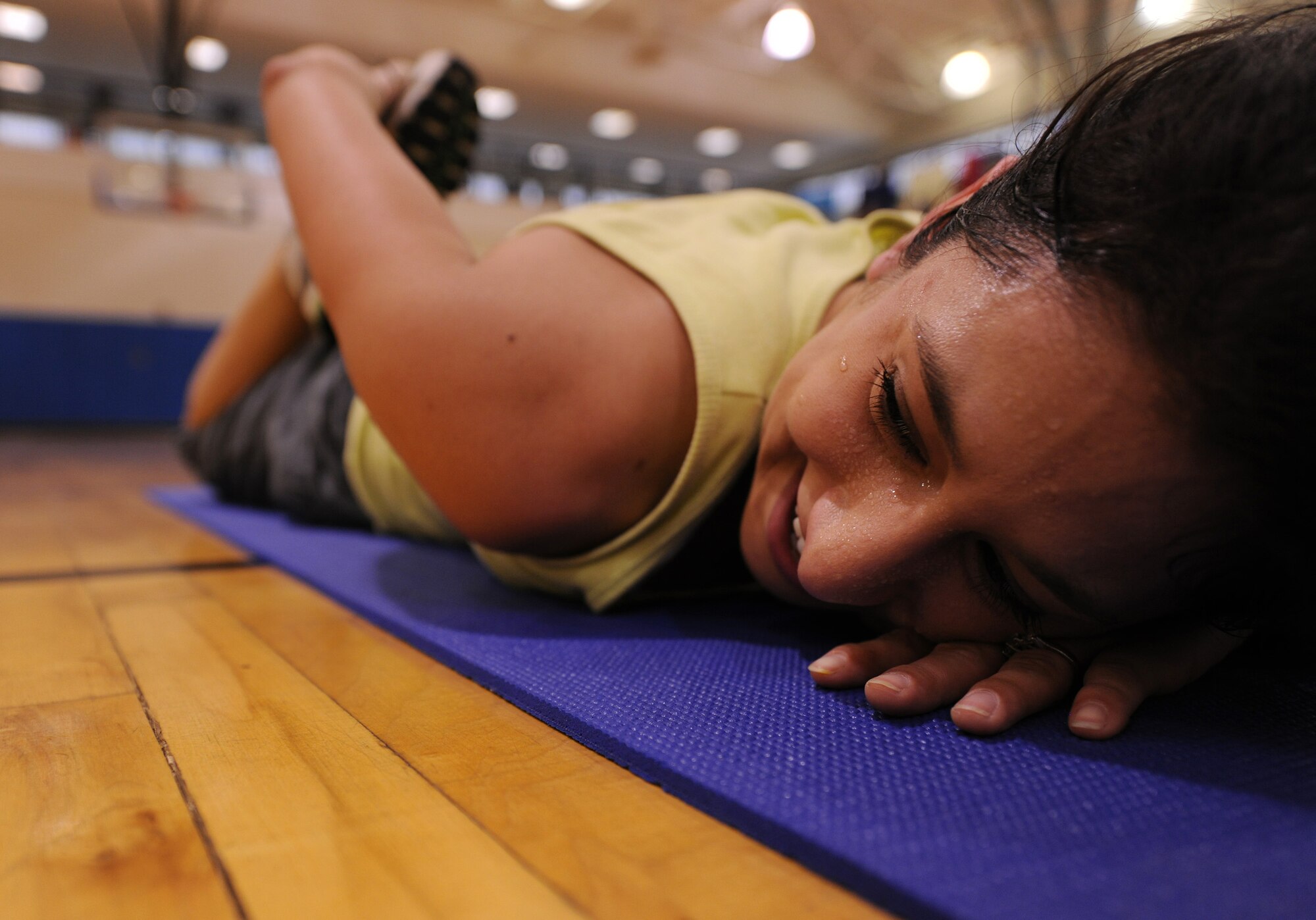 MOODY AIR FORCE BASE, Ga. -- Ashley Aguirre, 23rd Force Support Squadron recreation assistant, cools down and stretches after a session of group exercise here March 11. Mrs. Aguirre is the instructor of Mommy Boot Camp as well as other classes offered by the Freedom I Fitness Center. (U.S. Air Force photo by Airman 1st Class Benjamin Wiseman)